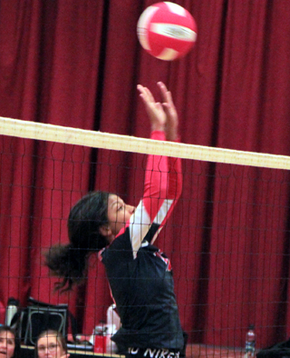 Trinity Martinez goes up to try to block a C.V. spike.