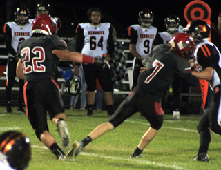 Quarterback Cole Schlader, 7, makes a block for Owen Anderson, 22, on a running play.