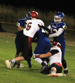 John Gehring, 6, and Dean Johnson combine to tackle Genesees quarterback.