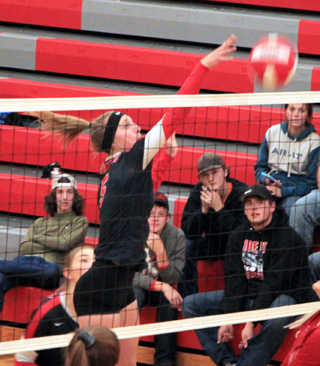 Ellea Uhlenkott tips the ball over against C.V. Seen behind Uhlenkott is Halle Klapprich.