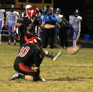 Owen Anderson was asked to try kicking extra points for the Lapwai game. He made 5 of 8 attempts. Holder is Sam Mager.
