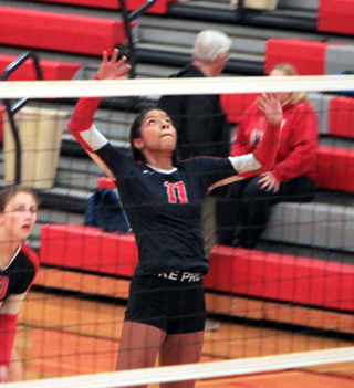 Trinity Martinez goes up for a spike at C.V. Unfortunately an injury ended her season 2 days later. Also shown is Erin Chmelik.
