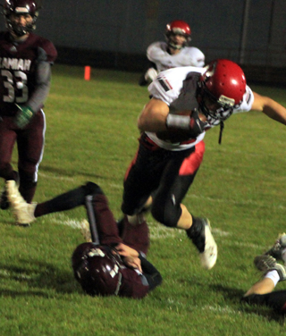 Cole Martin avoids a Kamiah player after making an interception which he took to the end zone for Prairies first touchdown of the game at Kamiah.