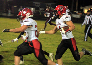 Owen Anderson and Dalton Ross (behind Anderson) provide blocking for Derik Shears on a punt return for a touchdown.