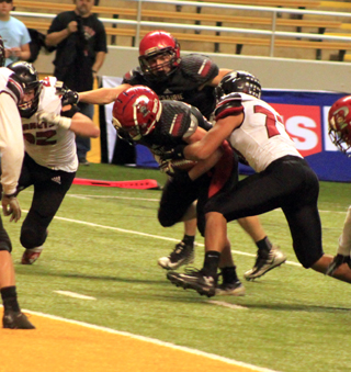 Owen Anderson powered his way through this attempted tackle to score the games first touchdown.