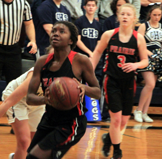 Madison Shears is about to score a lay-up at Grangeville. Also shown is Kristin Wemhoff.