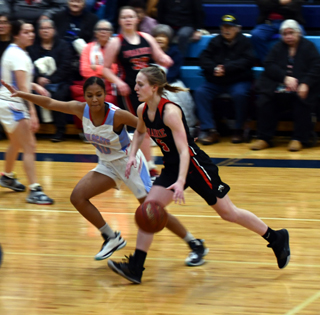 Ellea Uhlenkott drives past a Lapwai defender. In the background is India Peery. Photo by Cara Uhlenkott.