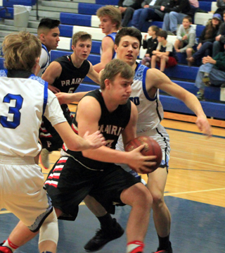 A determined looking Hayden Uhlenkott takes the ball to the hoop at Orofino. Also shown is Damian Forsmann.