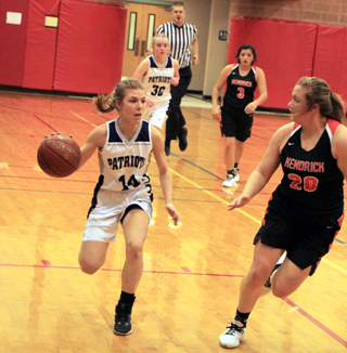Lexi Currier handles the ball against Kendrick. Jessie Sonnen can also be seen.