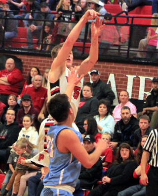 Damian Forsmann shoots for one of his seven 3-pointers against Lapwai in his final game at the Prairie gym.