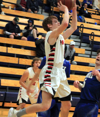 Cole Schlader puts up a shot against Genesee at District. Also shown is Brody Hasselstrom.