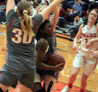 Madison Shears pushes through a couple of Grace defenders. Also shown is Tara Schlader.