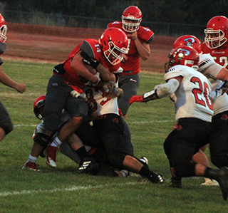 John Gehring and Jesse Cronan tackle a C.V. runner for a loss. Also shown is Brody Hasselstrom, 20.