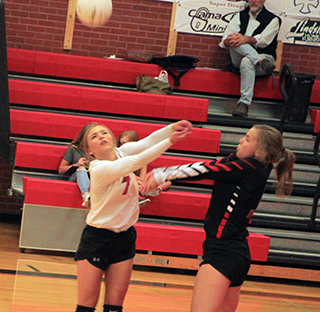 Sierra McWilliams and Delanie Lockett both go after a serve in the Logos match.