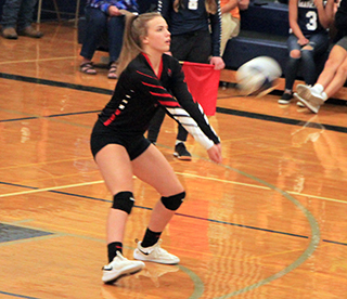 Delanie Lockett digs a serve at Grangeville.