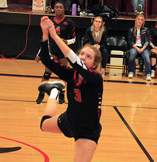 Tara Schlader chased down an errant pass against Potlatch and gets the ball over the net. Also shown is Madison Shears.