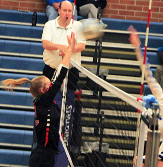 Ellea Uhlenkott goes for a block in the first Genesee match at District.