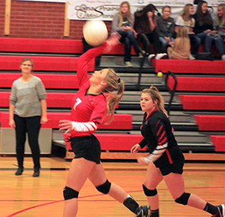 Sierra McWilliams spikes from the back row in the Potlatch District match that was played at Cottonwood. Also shown is Hope Schwartz.