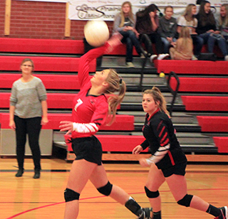 Sierra McWilliams spikes from the back row in the Potlatch District match that was played at Cottonwood. Also shown is Hope Schwartz.