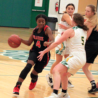 Madison Shears handles the ball at Potlatch. At right is Laney Forsmann.