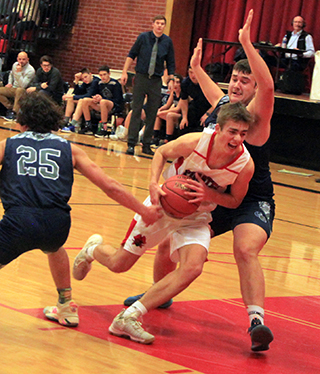 Zach Rambo takes the ball into the lane against Grangeville.