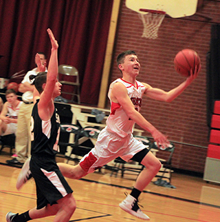 Tyler Wemhoff goes for a lay-up against Timberline.