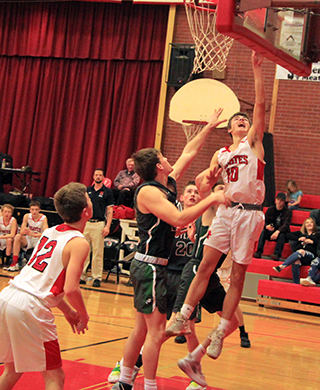 Zach Rambo scores a lay-up against Potlatch as Tyler Wemhoff watches.