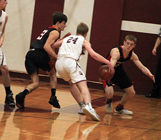 Cole Schlader makes a steal at Kamiah. Also shown is Wyatt Ross.