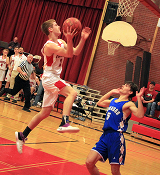 Cole Schlader goes for a lay-up in the first Genesee game at District.