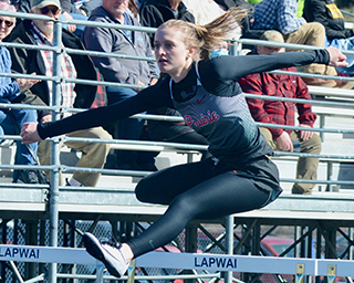Ellea Uhlenkott glides over a hurdle. Track photos courtesy of Andrew Ottoson, Idaho County Free Press.