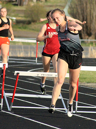Ellea Uhlenkott took 2 seconds off her best time ever in the 300 hurdles despite clipping this hurdle with her trail leg at the Prairie Meet last Thursday.