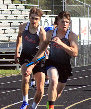 Zach Rambo hands off the lead to T.J. Hibbard in the 4x200 at Kamiah.