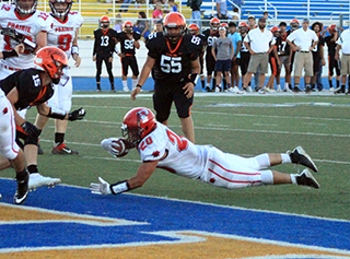 Brody Hasselstrom dives into the end zone for the 2-point conversion following Wyatt Ross’ touchdown pictured above. That gave Prairie a 30-8 halftime lead. Also shown is Noah Behler.