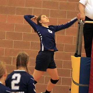 St. John Bosco’s Jade Prigge goes for a spike against Meadows Valley. Also shown is Julia Wassmuth.
