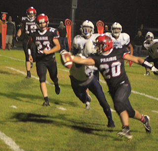 Brody Hasselstrom reaches the ball toward the end zone on one of his 6 touchdowns against Logos. Also shown are Shane Hanson and Chase Kaschmitter.