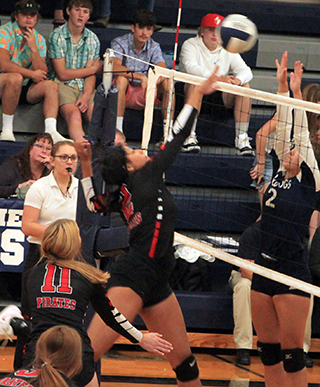 Trinity Martinez looks to tip the ball past Grangeville’s blockers. Also shown is Alli Geis.