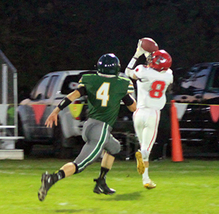 Wyatt Ross catches a long pass and wound up completing a 70 yard touchdown play to open the scoring in the game at Potlatch last Friday.