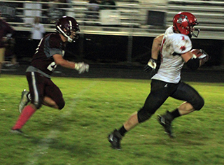 Tayden Hibbard pulls away from a Kamiah defender on a long touchdown run in the second half.