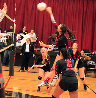 Josie Remacle spikes the ball on Senior Night vs. Grangeville. Also shown are Kristin Wemhoff, Trinity Martinez and Tara Schlader.