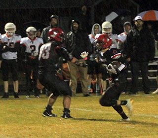 Wyatt Ross after making his second interception of the first quarter. It led to the Pirates’ first touchdown. Also shown is Jesse Cronan.