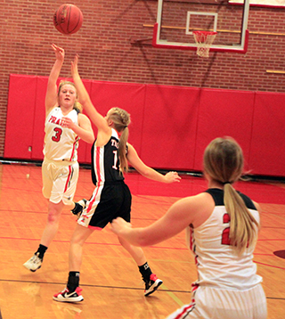 Kristin Wemhoff passes over a Troy defender to Molly Johnson.