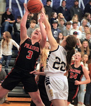 Kristin Wemhoff goes for a lay-up at Grangeville. Also shown is Laney Forsmann.