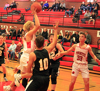 Kyle Schwartz goes for a lay-up against Timberline as Lee Forsmann watches.
