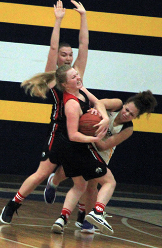 Kristin Wemhoff forces a jump ball at Logos. Also defending is Josie Remacle.
