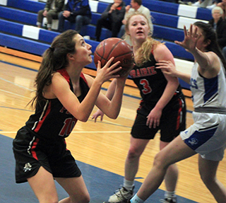 Ali Rehder looks to shoot at Orofino as Kristin Wemhoff looks on.