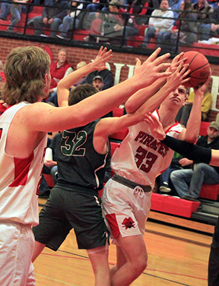 Lee Forsmann looks determined as he appears to get fouled on a shot against Potlatch. At left is Shane Hanson.