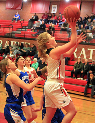 Kristin Wemhoff goes to the hoop against Genesee. Also shown is Lexi Schumacher.
