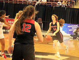 Tara Schlader brings the ball across halfcourt against Lapwai. Also shown are Kristin Wemhoff (partially hidden) and Josie Remacle.