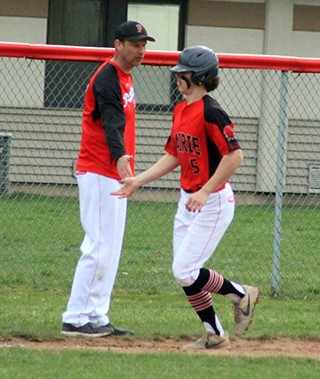 Chase Kaschmitter is congratulated by coach Kyle Westhoff as he rounds third after hitting a homer against North Star Charter.
