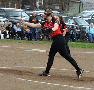 Mackenzie Key pitches against C.V. in Prairie’s opening game. Also shown is third baseman Kaylie Lockett.